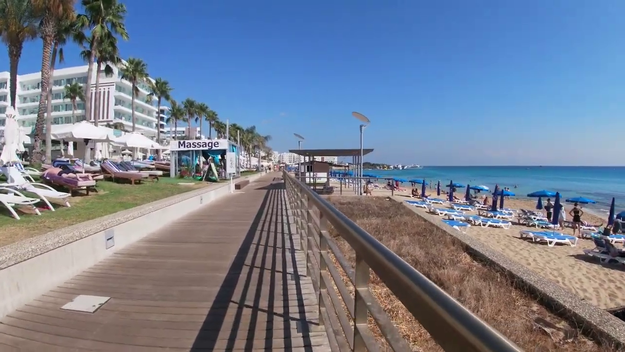 The hotels, the coastal Promenade of Protaras and the beach with the umbrellas and the sunbeds